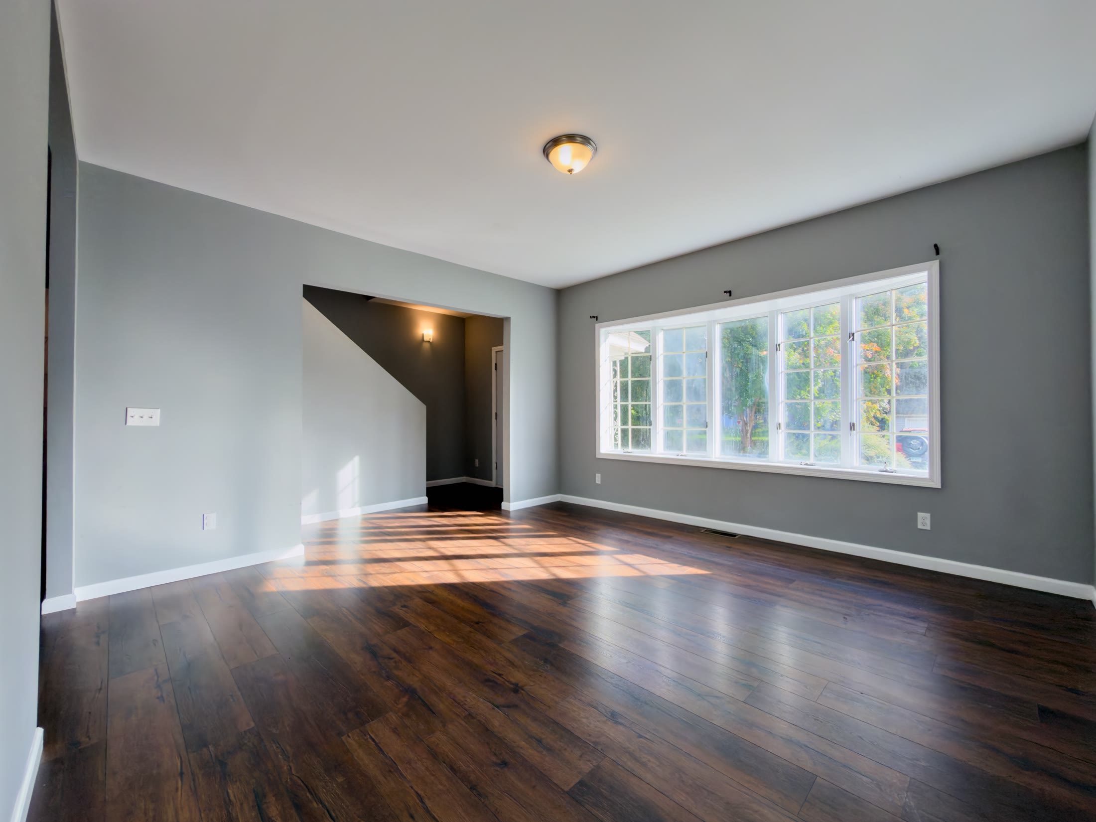 Living room with large window and hardwood floors